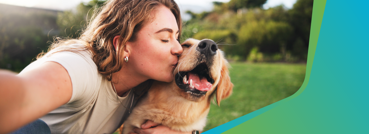women kissing a dog's face