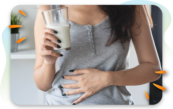 woman with upset stomach holding glass of milk