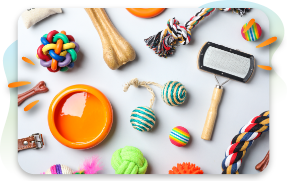 An assortment of colorful pet toys and accessories for both cats and dogs, including a water bowl, brushes, bones, and rope toys.